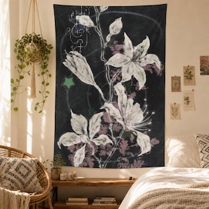 May include: A rectangular wall tapestry featuring a dark charcoal background with large, white, hand-drawn style lily flowers and buds. The design includes faint, dusty pink floral patterns, thin white circular lines, and small green star accents.