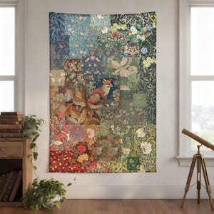 May include: A large tapestry featuring a patchwork design with floral patterns in shades of blue, green, and red. A fox is centered on the tapestry. The tapestry is hanging on a wall near a window.
