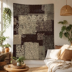 May include: A rectangular wall tapestry featuring a dark brown and light gray patchwork design with intricate floral and damask patterns. The textile displays a distressed, vintage-inspired aesthetic with varied rectangular blocks of repeating motifs.