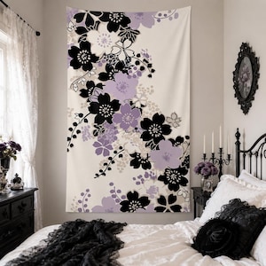 May include: A rectangular wall tapestry featuring a floral pattern with black, light purple, and cream-colored blossoms arranged in a cascading diagonal design. The fabric displays stylized flower shapes and delicate vine-like details.