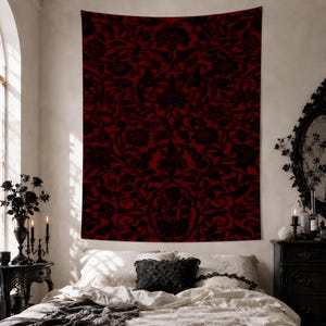 May include: A rectangular wall tapestry featuring a deep red background with a repeating black damask floral pattern. The design consists of intricate botanical motifs, including stylized flowers and swirling vines, covering the entire surface.