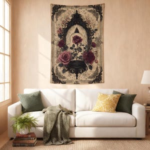 May include: A rectangular wall tapestry featuring a central illustration of a single dark red rose encased in a glass cloche, surrounded by ornate black filigree frames and additional rose blooms on a beige background with vintage-style patterns.