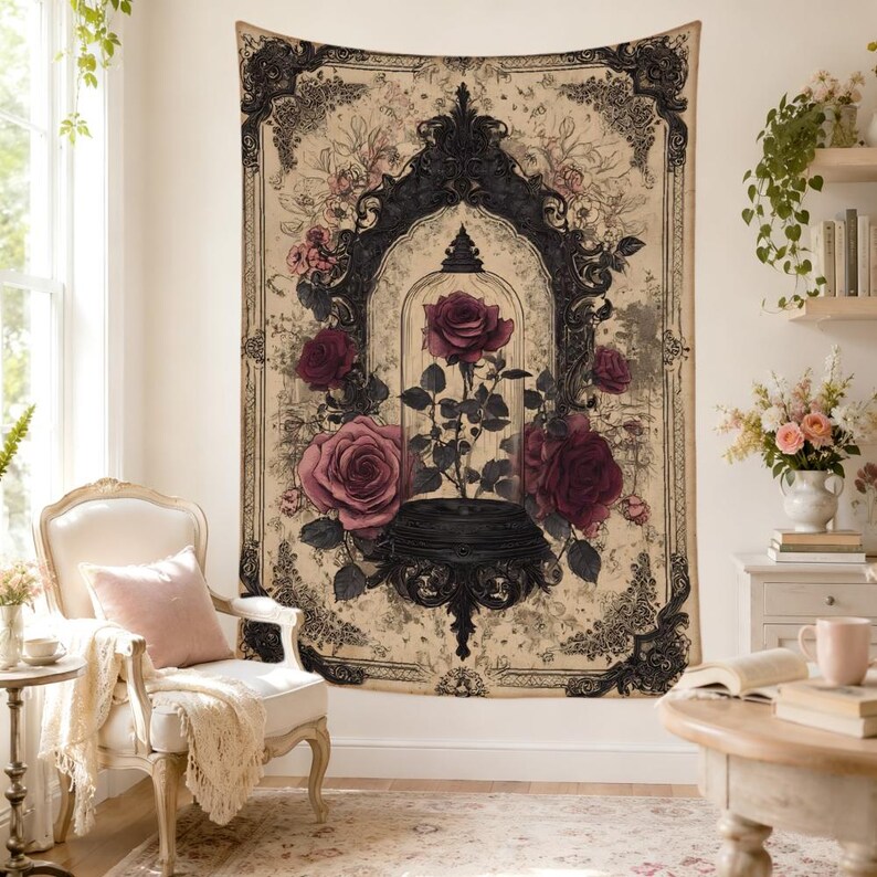 May include: A rectangular wall tapestry featuring a central illustration of a single dark red rose inside a glass cloche, surrounded by larger blooming roses. The design is framed by an ornate black border on a cream-colored, vintage-style background.