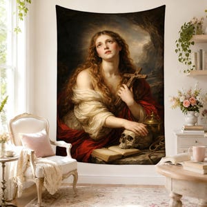 May include: A wall tapestry featuring a classical oil painting of a long-haired figure in a red and white robe, holding a wooden crucifix. The figure rests a hand on a human skull placed next to an open book, set against a dark, dramatic background.