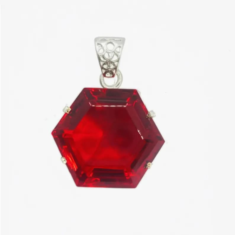 Handmade ruby hexagon pendant on white background