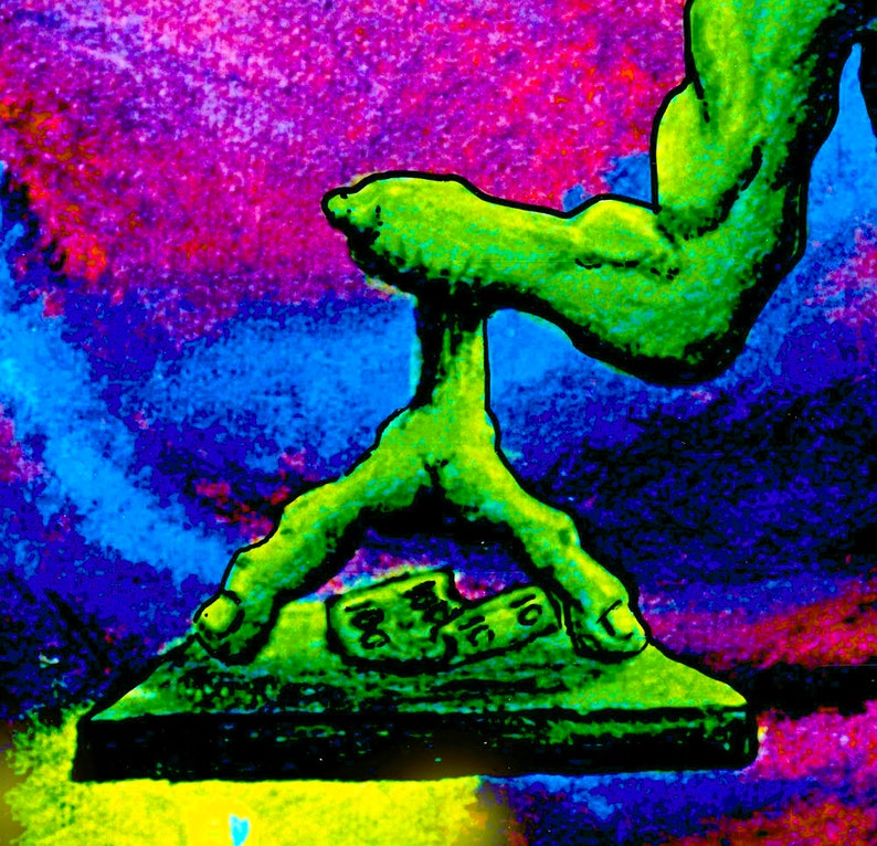 May include: A green, three-fingered hand with a large arm reaching down to press on a black platform. The platform has a green, textured surface and a green, textured object on top of it. The background is a vibrant mix of pink, purple, blue, and green.
