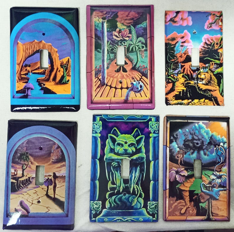 May include: Six decorative light switch covers with colorful, surrealist artwork. Each cover features a unique design, including landscapes, a gargoyle, and fantastical creatures. The covers have a glossy finish and are rectangular with a toggle switch opening.