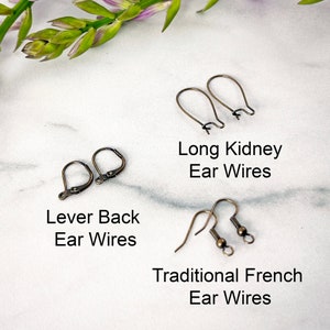 Photo reference of the three ear wire styles available which include traditional French ear wires, lever beck ear wires, and long kidney ear wires. All ear wires are in the antique brass style.