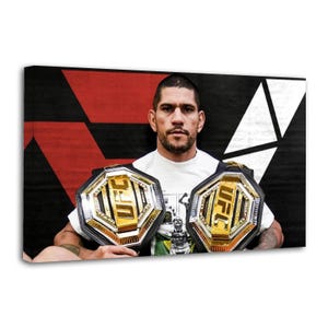 May include: A canvas print featuring a man holding two UFC championship belts. The belts are gold and black with the UFC logo. The background is black, red, and white.