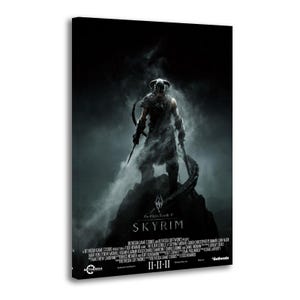 May include: A canvas print of the video game "Skyrim". The image features a warrior figure in armor, holding weapons, standing on a rocky peak. The background is dark and smoky, with the game's title and credits at the bottom.