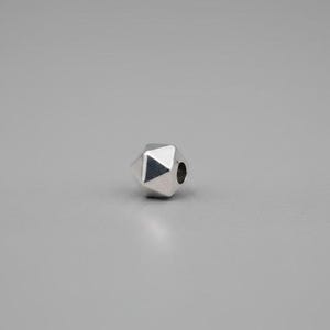 May include: A single, faceted silver bead with a geometric design. The bead has multiple flat surfaces and a hole for stringing. The bead is shown against a gray background.