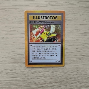 May include: A white ceramic mug with a black handle and the text "But First, Coffee" in a handwritten style. The mug is on a white surface. The mug is approximately 10 cm tall.