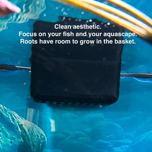 May include: A black square aquarium basket submerged in blue water. The text "Clean aesthetic. Focus on your fish and your aquascape. Roots have room to grow in the basket." is visible.