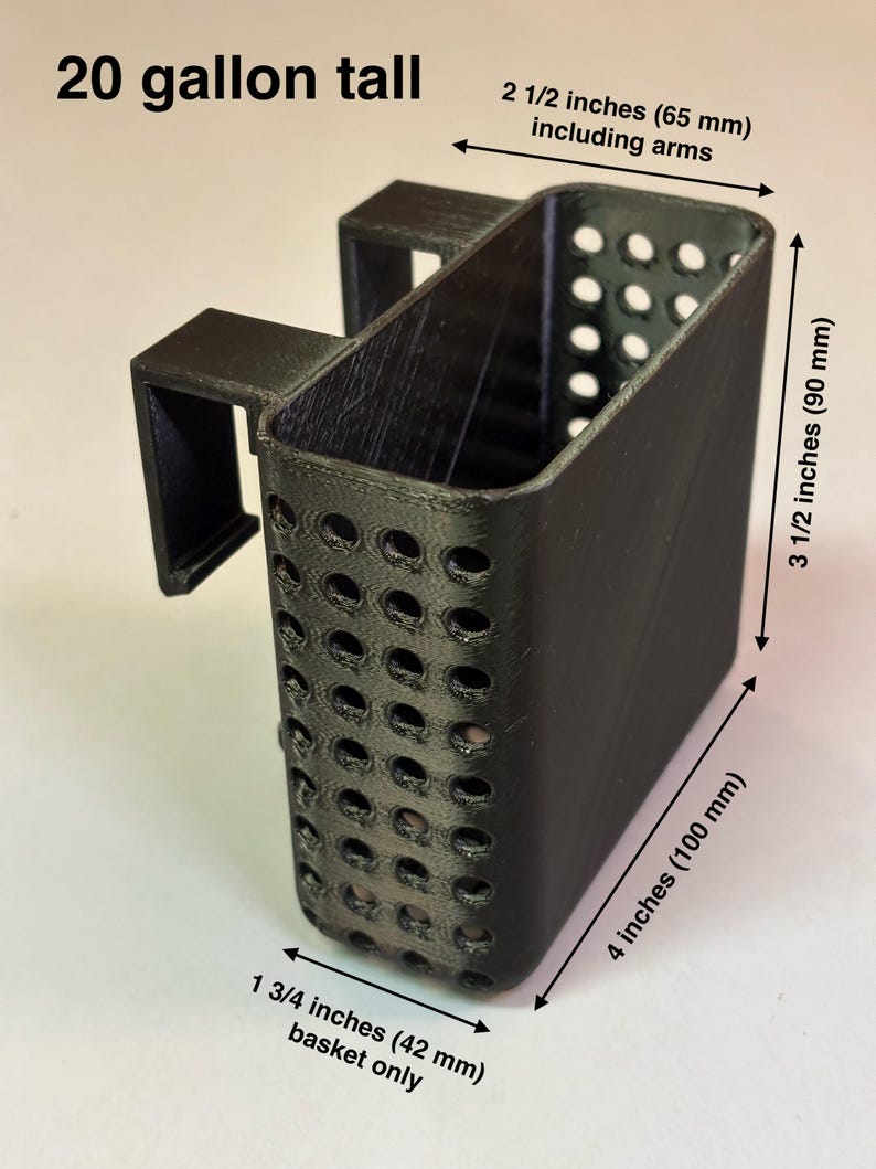 May include: A black, rectangular basket with a handle, featuring numerous circular perforations. The basket is 4 inches (100 mm) long, 3 1/2 inches (90 mm) tall, and 1 3/4 inches (42 mm) wide. The text "20 gallon tall" is visible.