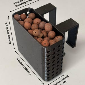 May include: Black 3D-printed basket, 4 inches (100mm) long, filled with brown pebbles. The basket has a perforated design and is designed to hang on the edge of a 75-gallon container. The basket is 3 inches (75mm) wide including arms.