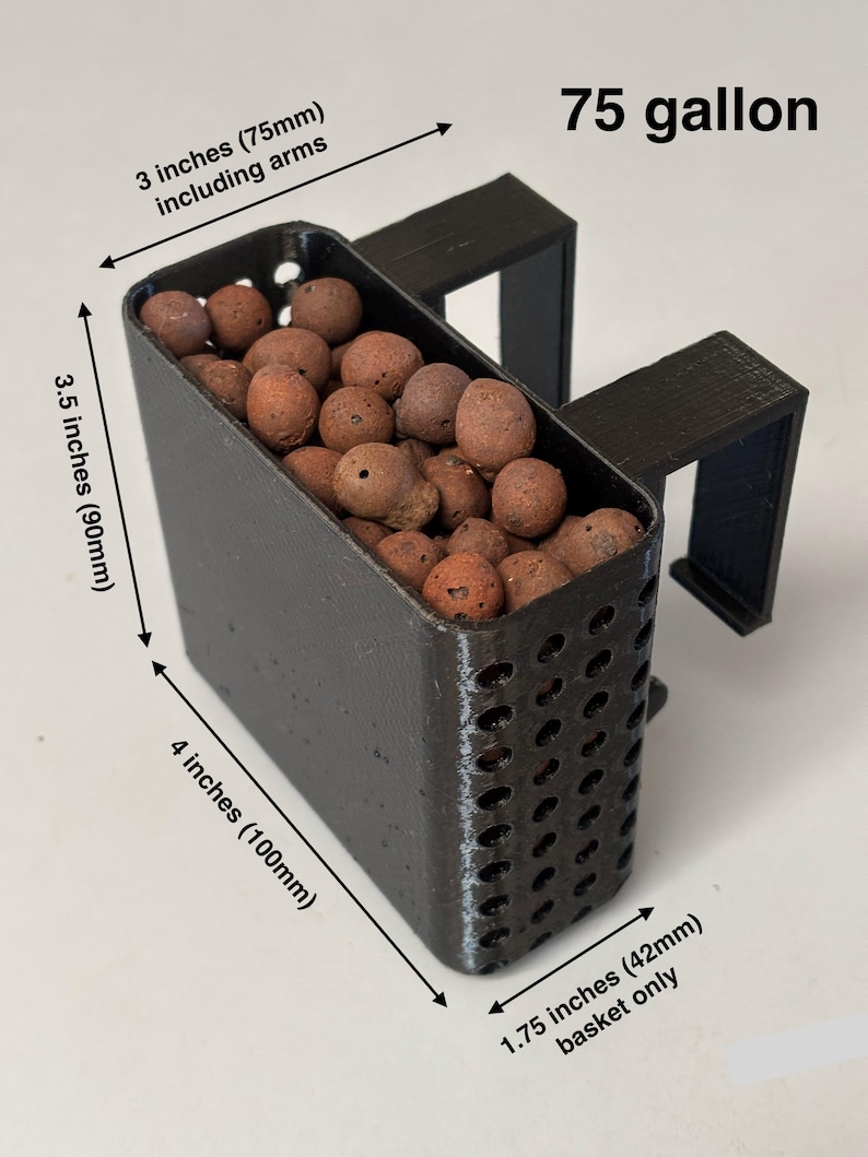 May include: Black 3D-printed basket, 4 inches (100mm) long, filled with brown pebbles. The basket has a perforated design and is designed to hang on the edge of a 75-gallon container. The basket is 3 inches (75mm) wide including arms.