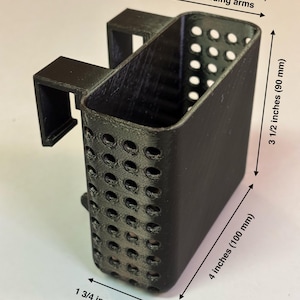 May include: Black rectangular basket with perforated sides, designed for aquarium use. The basket measures 4 inches (100 mm) long, 3 1/2 inches (90 mm) high, and 1 3/4 inches (42 mm) wide. Includes arms that extend 2 1/2 inches (65 mm). Text reads "29 gallon & 20 gallon long".