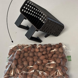 May include: A black plastic plant pot with many small holes, supported by legs, sits above a clear plastic bag filled with brown LECA growing medium. Text reads: "Includes LECA growing medium!" and "Need a plant cutting? Check out my bundle listing!"
