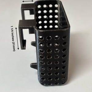 May include: Black plastic 10-gallon aquarium filter holder. The holder is 3/4 inches (19mm) wide and 1 1/4 inches (31mm) tall. The holder has many small holes and is designed to hold a filter.