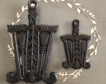 Two Vintage Grain and Tassel Footed Cast Iron Trivets Large and Small