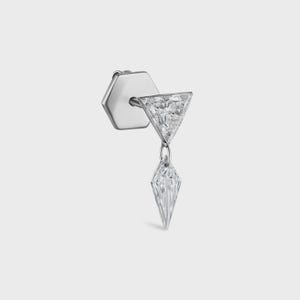 May include: A single silver earring with a geometric design. The earring features a hexagonal post, a triangular top, and a dangling, diamond-shaped bottom, all in a clear, sparkling material. The earring is set against a plain, light background.