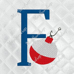 May include: Blue embroidered letter "F" with a red and white fishing bobber attached by a black fishing line. The background is a white quilted pattern. The text "May Sundrop" is watermarked across the image.