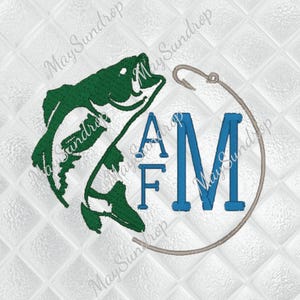 May include: Green bass fish graphic with a fishing hook and the letters "AFM" in blue, inside a circle. The design is on a white, quilted background. The design is likely for fishing enthusiasts.