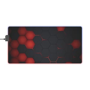May include: Rectangular gaming mouse pad with a black and red honeycomb pattern. The pad has a glowing blue edge and a small black power adapter attached to the side.
