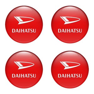 May include: Four red, glossy, circular Daihatsu logo stickers. Each sticker features the Daihatsu logo in white, a stylized wing design above the brand name. The stickers are arranged in a 2x2 grid.