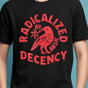 May include: Black t-shirt with a red graphic. The graphic features a bird holding a sprig, surrounded by the words "RADICALIZED BY BASIC DECENCY" in a circular design. A simple, bold design.