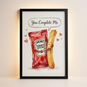 May include: Framed watercolour print showing a Heinz tomato ketchup sachet embracing a french fry, with the text "You Complete Me" in a speech bubble. Small heart illustrations are also included.