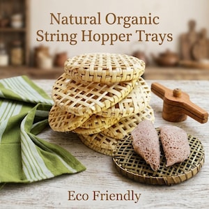 May include: A stack of round, light-tan woven bamboo string hopper trays with a grid pattern. One tray sits separately with two folded, light purple string hoppers on top. A wooden press tool and a green and white striped cloth are nearby.