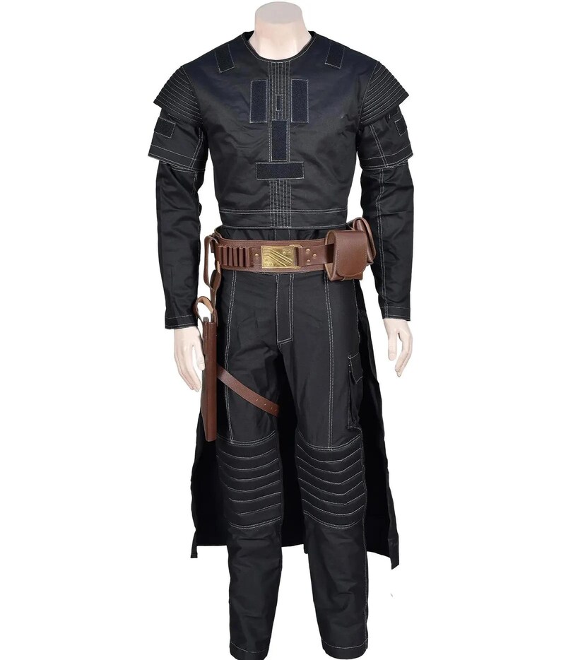 May include: A black long-sleeved shirt and matching pants set featuring white contrast stitching, shoulder padding, and ribbed knee panels. A brown utility belt with a gold buckle, attached pouches, and a holster is worn over the outfit.