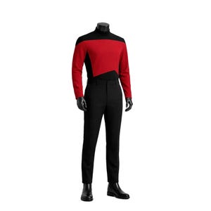 May include: A long-sleeved mock neck shirt featuring a vibrant red chest panel contrasted with black sleeves and side sections, paired with solid black trousers. The ensemble is displayed on a mannequin, complete with black boots and black gloves.