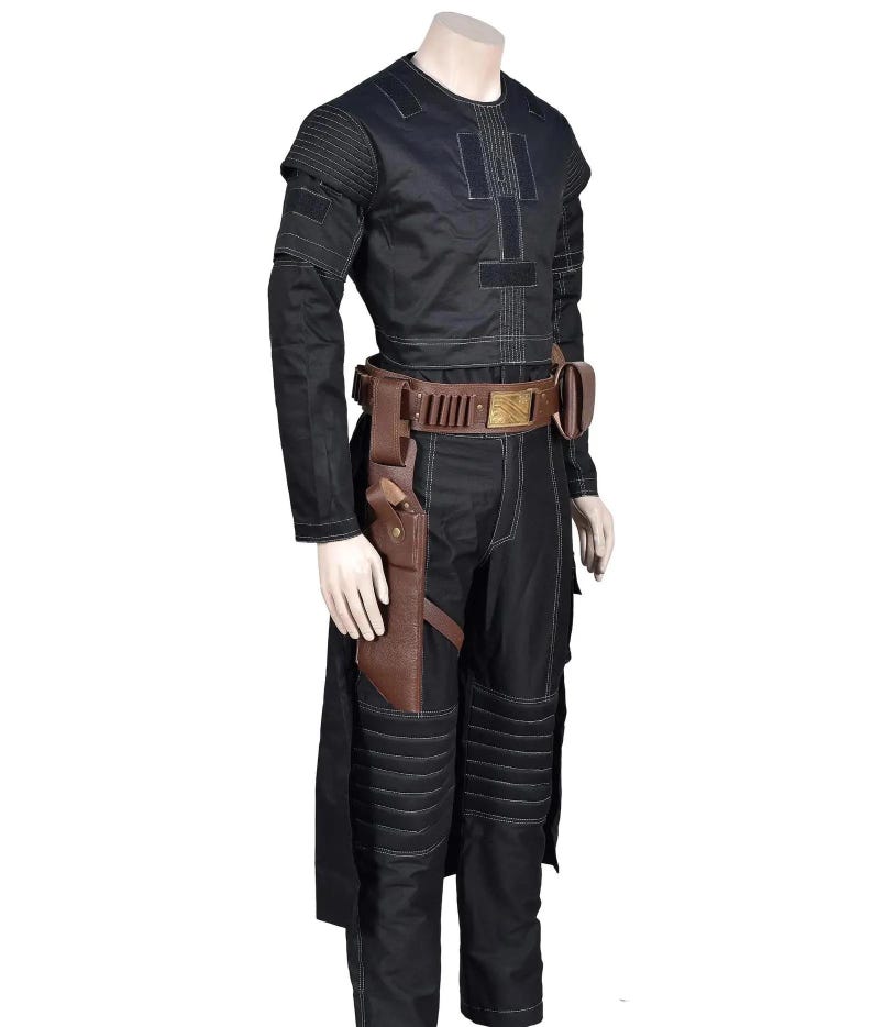 May include: A black long-sleeved shirt and matching trousers featuring white topstitching, ribbed shoulder and knee panels, and a brown leather utility belt with a holster and gold-toned buckle worn over the waist of the black trousers.