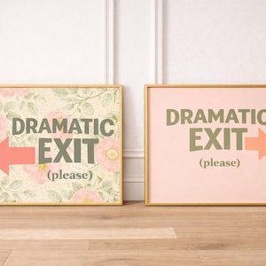 May include: Two framed art prints with gold frames. One features a floral background with the words "DRAMATIC EXIT (please)" and an arrow. The other has a pink background with the same text and arrow.