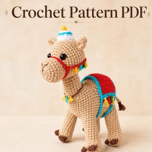 May include: A crocheted camel toy in tan with a red and blue saddle, a red bridle, and a small hat. The text "Crochet Pattern PDF" is at the top of the image. The camel has decorative tassels and is standing on a neutral background.