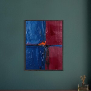 May include: Abstract oil painting in a dark wooden frame. The artwork is divided into four quadrants, with two blue and two red sections. A small orange area is visible in the center. The painting has a textured, impasto style.
