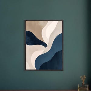 May include: Abstract art print with layered, flowing shapes in navy blue, beige, and off-white. The artwork is framed in a dark wood frame and hangs on a dark teal wall. The overall theme is modern and minimalist.