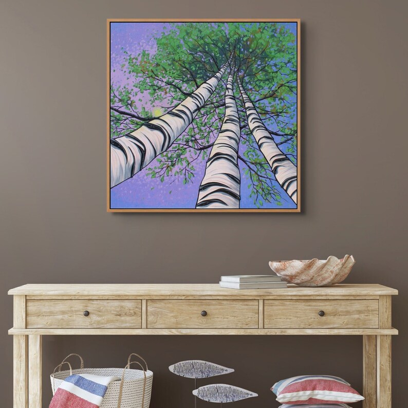 Large birch tree painting shown in room over wooden bench.