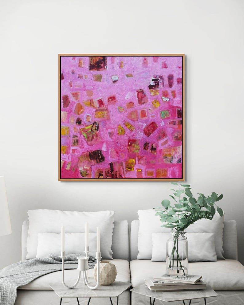 Pink and orange expressionist painting making a bold statement in a white room.