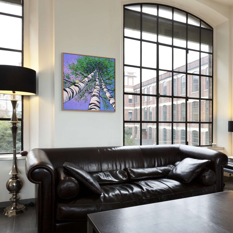 Large square birch tree painting of trees looking up in swanky city apartment.