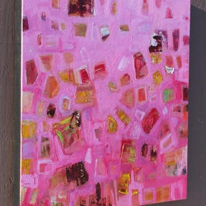 Side view of lively pink and orange abstract with shapes in cool and warm tones.