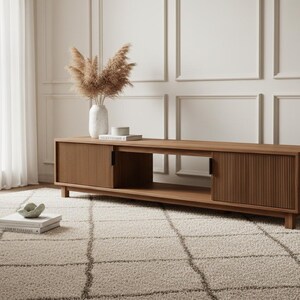 70 inch mocha fluted TV stand styled in modern living room with large flat screen TV