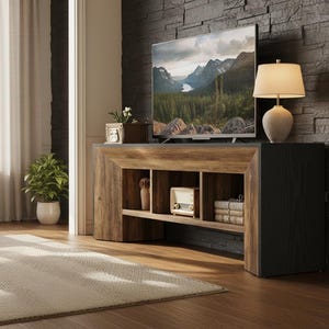 May include: A wooden TV stand with open shelving, a black side panel, and a gray top. A flat-screen TV displays a mountain landscape. A lamp with a beige shade sits on top. A rug and a plant are in the foreground.