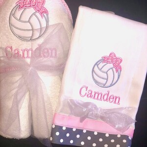 May include: White towel set with pink and black polka dot trim. The towels feature an embroidered volleyball with a pink bow and the name "Camden".