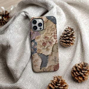 May include: A rectangular smartphone case featuring a patchwork design of various fabric textures, including floral patterns, lace trim, and muted earth tones like beige, sage green, dusty rose, and slate blue, with a central rose bouquet motif.