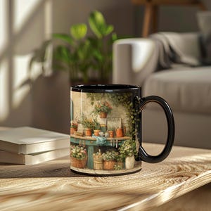May include: Black coffee mug with a wrap-around garden scene featuring a potting table, plants, and flowers. The mug has a black handle and rim. The design includes a variety of potted plants, gardening tools, and a rustic potting bench.