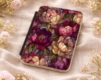 May include: A rectangular phone case featuring a floral design with peonies in shades of pink, purple, and yellow. The case has a black border and is set against a soft, neutral background with floral accents.