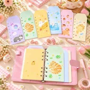 May include: A set of six pastel-colored, punched planner inserts featuring various cat and dog illustrations, shown both individually and organized within a pink six-ring binder. The paper sheets display colorful animal graphics, stars, and small icons.